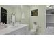 Bright bathroom features a white vanity, toilet, storage cabinet, and framed window at 1195 Oglethorpe Ne Ave, Atlanta, GA 30319