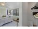 Bright bedroom featuring a closet, large windows, hardwood floors, and neutral decor at 1195 Oglethorpe Ne Ave, Atlanta, GA 30319