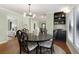 Elegant dining room features hardwood floors, contemporary chandelier, and access to bedroom at 1195 Oglethorpe Ne Ave, Atlanta, GA 30319