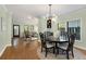 Stylish dining room with hardwood floors, modern lighting, and open layout to living room at 1195 Oglethorpe Ne Ave, Atlanta, GA 30319