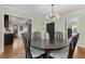 Open-concept dining room with hardwood floors, modern decor, and access to kitchen at 1195 Oglethorpe Ne Ave, Atlanta, GA 30319