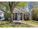 Charming single-story home featuring a well-manicured front yard with an American flag and stone accents at 1195 Oglethorpe Ne Ave, Atlanta, GA 30319