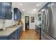Well-lit kitchen featuring navy cabinets, stainless steel appliances, and hardwood floors at 1195 Oglethorpe Ne Ave, Atlanta, GA 30319