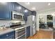 A charming kitchen features navy cabinets, stainless steel appliances, and hardwood floors at 1195 Oglethorpe Ne Ave, Atlanta, GA 30319