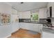 Bright kitchen featuring white cabinets, stainless steel appliances, and hardwood floors at 1195 Oglethorpe Ne Ave, Atlanta, GA 30319