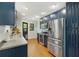 Modern kitchen with navy cabinets, stainless steel appliances, and hardwood floors at 1195 Oglethorpe Ne Ave, Atlanta, GA 30319