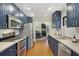 Open kitchen with navy cabinets, stainless steel appliances, and access to the dining area at 1195 Oglethorpe Ne Ave, Atlanta, GA 30319