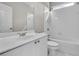 Clean bathroom with white tiles, a white sink and vanity, and a tub and shower combination at 1410 White Flowers Ln, Lawrenceville, GA 30045