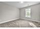 Neutral bedroom with a window offering natural light and neutral carpet at 1410 White Flowers Ln, Lawrenceville, GA 30045