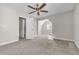 Bedroom with ceiling fan and open door to an attached bathroom at 1410 White Flowers Ln, Lawrenceville, GA 30045