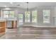 Dining Area with light wood cabinets, stainless steel dishwasher and a sliding door to backyard at 1410 White Flowers Ln, Lawrenceville, GA 30045