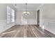 Dining room showcasing hardwood floors, elegant chandelier, and wainscoting details at 1410 White Flowers Ln, Lawrenceville, GA 30045