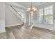 Dining room with hardwood floors, a chandelier, staircase, and large windows at 1410 White Flowers Ln, Lawrenceville, GA 30045