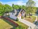 Two-story home with brick and siding, a driveway, and a manicured lawn at 1410 White Flowers Ln, Lawrenceville, GA 30045