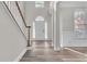 Bright foyer featuring hardwood floors, white columns, and a staircase at 1410 White Flowers Ln, Lawrenceville, GA 30045