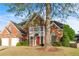 Beautiful red brick home with a well manicured lawn, two car garage, and balcony at 1410 White Flowers Ln, Lawrenceville, GA 30045