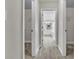 Hallway featuring carpet and access to the closets and ensuite bathroom at 1410 White Flowers Ln, Lawrenceville, GA 30045