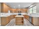 Well-equipped kitchen with wood cabinets, center island, stainless steel appliances, and ample counter space at 1410 White Flowers Ln, Lawrenceville, GA 30045