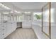 Bright main bathroom with double vanity, a tub and a glass shower at 1410 White Flowers Ln, Lawrenceville, GA 30045