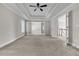Expansive main bedroom with bright neutral tones and tray ceilings at 1410 White Flowers Ln, Lawrenceville, GA 30045