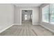 Sitting room with bright natural light, neutral carpet and neutral walls at 1410 White Flowers Ln, Lawrenceville, GA 30045