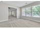 Sitting room featuring large bright windows and neutral carpet at 1410 White Flowers Ln, Lawrenceville, GA 30045