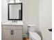 Contemporary half-bath with a modern vanity, stylish mirror, and sleek fixtures at 2065 Mozelle Dr, Marietta, GA 30062