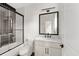 Bathroom featuring a marble countertop vanity and a sleek black-framed shower with a glass door at 2065 Mozelle Dr, Marietta, GA 30062
