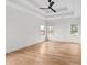 Spacious bedroom features tray ceilings, a ceiling fan, hardwood floors, and plenty of natural light at 2065 Mozelle Dr, Marietta, GA 30062