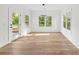 Bright dining room boasts hardwood floors, natural light from the windows, and contemporary pendant lighting at 2065 Mozelle Dr, Marietta, GA 30062