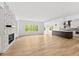 Open-concept living room showcases hardwood floors, fireplace, and seamless flow into the kitchen at 2065 Mozelle Dr, Marietta, GA 30062