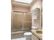 Bathroom featuring a tub with glass doors, marble sink, and white cabinet at 3312 Winter Wood Ct, Marietta, GA 30062