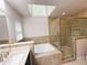 Bright bathroom features a soaking tub, glass enclosed shower, and skylight at 3312 Winter Wood Ct, Marietta, GA 30062