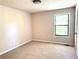 Empty bedroom with neutral paint and new carpet and a light fixture at 3312 Winter Wood Ct, Marietta, GA 30062