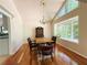 Charming dining area with hardwood floors, chandelier lighting, and window views of a lush backyard at 3312 Winter Wood Ct, Marietta, GA 30062