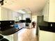 Bright kitchen features white cabinets, black countertops, stainless steel appliances and a skylight at 3312 Winter Wood Ct, Marietta, GA 30062