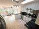 Modern kitchen with tile floors, a skylight, stainless steel appliances, and backyard views from the sink at 3312 Winter Wood Ct, Marietta, GA 30062