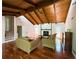Cozy living room featuring hardwood floors, a stone fireplace, wood beams, and comfortable seating at 3312 Winter Wood Ct, Marietta, GA 30062