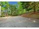Large concrete patio features playground and retaining wall with ample entertaining space at 3338 Hackmatack Nw Dr, Kennesaw, GA 30152