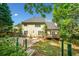 Spacious backyard featuring a patio, wooden deck, and lush greenery at 3338 Hackmatack Nw Dr, Kennesaw, GA 30152