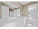 Bathroom featuring double vanity, large mirror, and white cabinetry at 3338 Hackmatack Nw Dr, Kennesaw, GA 30152