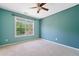 Cozy bedroom features a large window and soft carpet, bathed in natural light at 3338 Hackmatack Nw Dr, Kennesaw, GA 30152