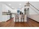 Well-lit kitchen with white cabinets, a breakfast bar, and hardwood floors at 3338 Hackmatack Nw Dr, Kennesaw, GA 30152