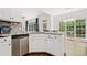 Well-lit kitchen featuring stainless steel appliances, granite countertops, and white cabinetry at 3338 Hackmatack Nw Dr, Kennesaw, GA 30152