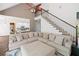 Spacious living room with a soaring ceiling, staircase, and a comfortable sectional sofa at 3338 Hackmatack Nw Dr, Kennesaw, GA 30152