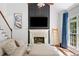 Inviting living room featuring a fireplace, large windows, and neutral decor at 3338 Hackmatack Nw Dr, Kennesaw, GA 30152