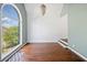 Spacious living room with hardwood floors, a large arched window, and stairs to the upper level at 3338 Hackmatack Nw Dr, Kennesaw, GA 30152