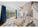 Bright living room with vaulted ceiling, large windows, hardwood floors, and a large sofa at 3338 Hackmatack Nw Dr, Kennesaw, GA 30152