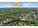 Aerial view of a home in a wooded neighborhood with nearby access to Atlanta, Duluth, and Stone Mountain at 4680 Glen Level Dr, Sugar Hill, GA 30518
