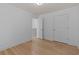 Bright bedroom featuring hardwood floors, neutral walls, and a convenient closet at 4680 Glen Level Dr, Sugar Hill, GA 30518